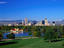 Skyline with Rocky Mountains in background, with City Park lake in foreground.