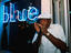 Feeling blue: harmonica player outside club on 7th Avenue