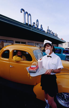 Bubble gum-blowing waitress at 1950's diner.
