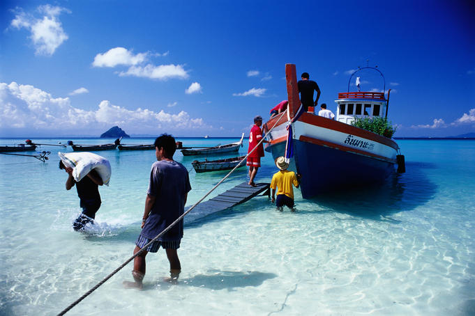 Unloading a supply ship on Hat Laem Tong on Ko Phi-Phi Don