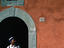 Workman beneath a stone arch in a stuccoed painted wall in Pisa.