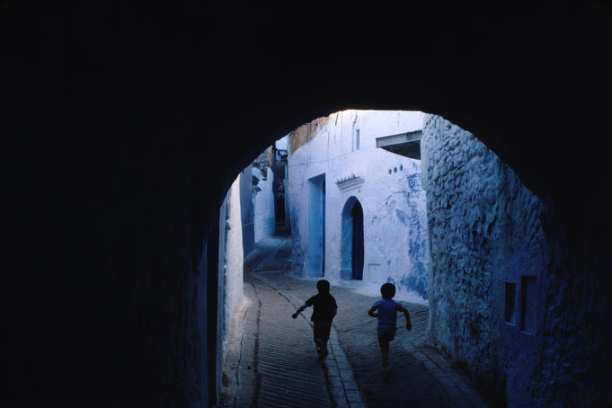 Two boys running through Kasbah, Chefchaouen