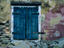 Painted stucco wall and wooden shutter.