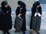 Three women in traditional dress at the Festival of Assumption of Mary.