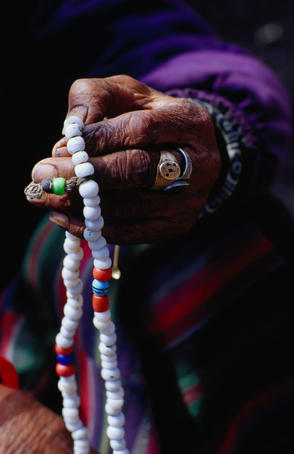 Loba nomad counting prayer beads.