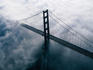 Aerial view of Golden Gate Bridge in clouds.