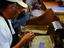 Man rolling cigars, San Diego
