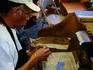 Overhead of man rolling cigars.