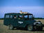 Safari jeep with a cheetah (Acinonyx jubatus) on the roof.