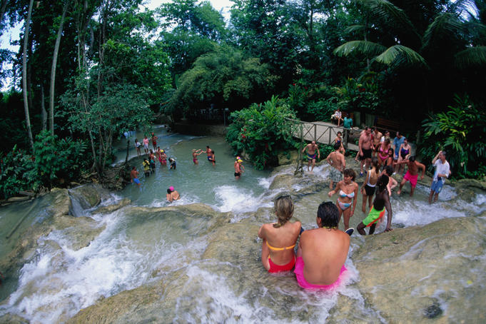 People enjoying the cascading waters of Dunn's River Falls.