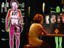 Woman at Technology and the Human Body display, Science Center.