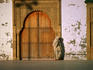 Muslim woman standing in a doorway.