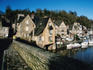 Yachts in front of buildings of old walled town.