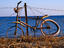 Broken-down bike against barbed wire fence.