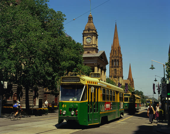Trams trundle along Swanston Street in the city centre.