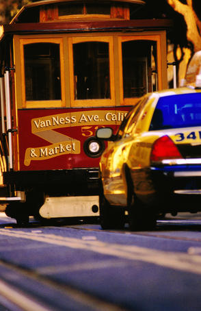 Cable car and taxi on California street.