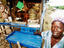 Man and tourist goods stall.