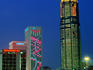 Illuminated city buildings.