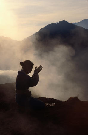 Woman leaving an offering on Mt Batur.