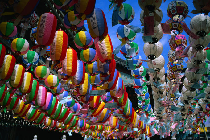 Strings of colourful paper lanterns suspended outside temple.