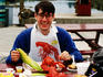 Portrait of man eating lobster and corn.