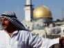 Man standing in front of the Dome of the Rock.