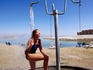 Woman showering at Dead Sea beach.