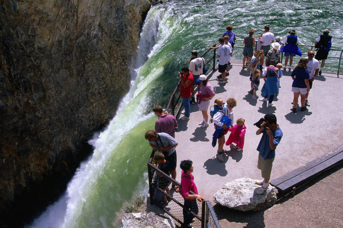 Tourists on the Lower Falls lip, Yellowstone Falls in Yellowstone National Park.