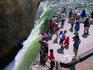 Tourists on the Lower Falls lip, Yellowstone Falls in Yellowstone National Park.