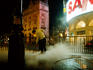 Street cleaner at Piccadily Circus at night.
