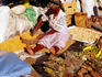 Herbalist preparing traditional medicine at Herb Market.