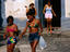 Two young girls walking on street.