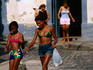 Two young girls walking on street.