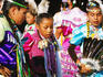 Native AMerican Indian girls in traditional dresses practice dance outside dance competition arena at Mashantucket Pequot Tribal Nation hosted Schemitzun Powwow.