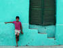 Boy standing against a wall.