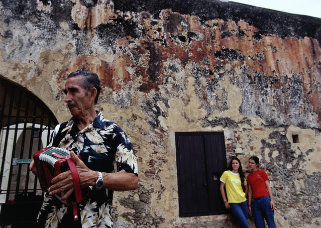 Man playing accordian at Castillo de San Christobel.