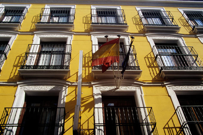 Wrought-iron balconies on city buildings facade.