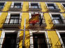 Wrought-iron balconies on city buildings facade.