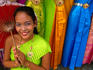 Girl selling dresses and costume materials outside Temple of Dawn.