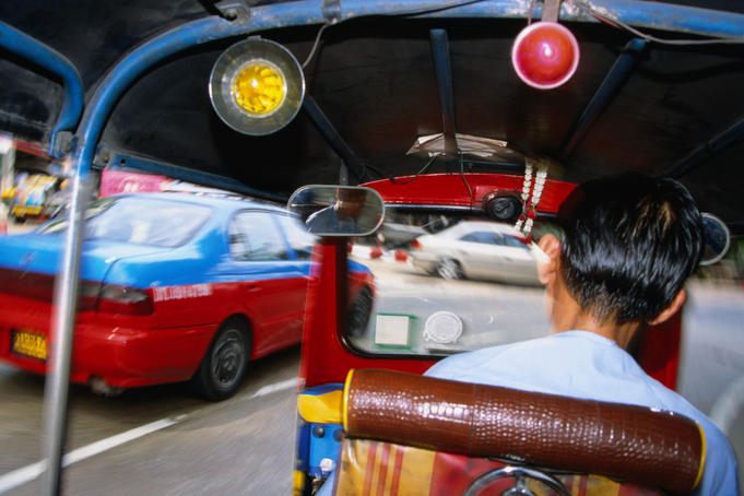 In the back of a tuk-tuk taxi.