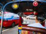 In the back of a tuk-tuk taxi.
