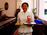 Portrait of waitress at Raffles Hotel with Singapore Sling.