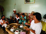 Malay family and friends eating indoors.