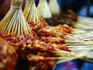 Uncooked satay at evening stall.