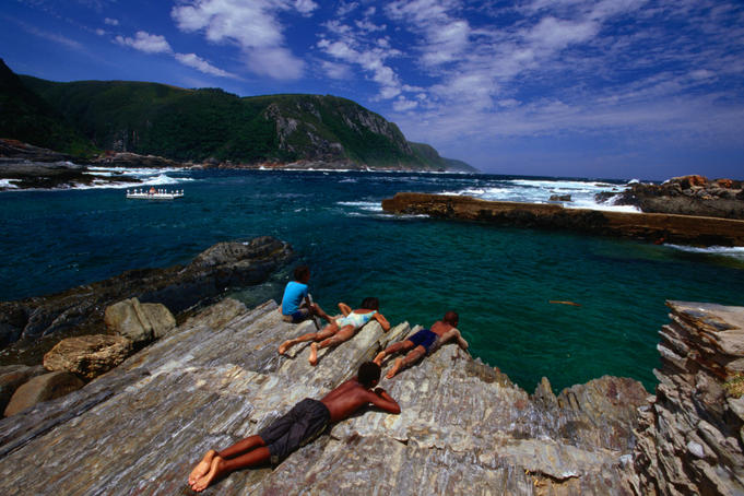 A snorkeller enjoys the trails while other sun and watch at the Tsitsikamma Coastal National Park.