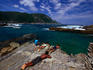 A snorkeller enjoys the trails while other sun and watch at the Tsitsikamma Coastal National Park.