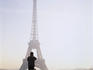 Tourist taking photograph of the Eiffel Tower.
