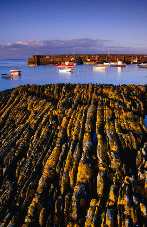 View over weathered rock to the pier.