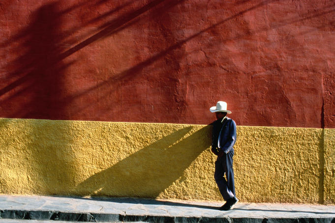 Man leaning against wall.