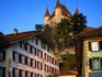 Medieval Castle on hill with cafes in foreground.